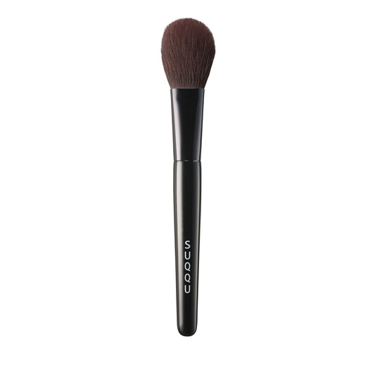 SUQQU Face Color Brush luxury Japanese synthetic artisan professional grade make up brush for blusher and contouring on plain background.