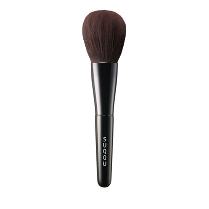 SUQQU Face Powder Brush luxury Japanese synthetic artisan professional grade make up brush for face powder on plain background.