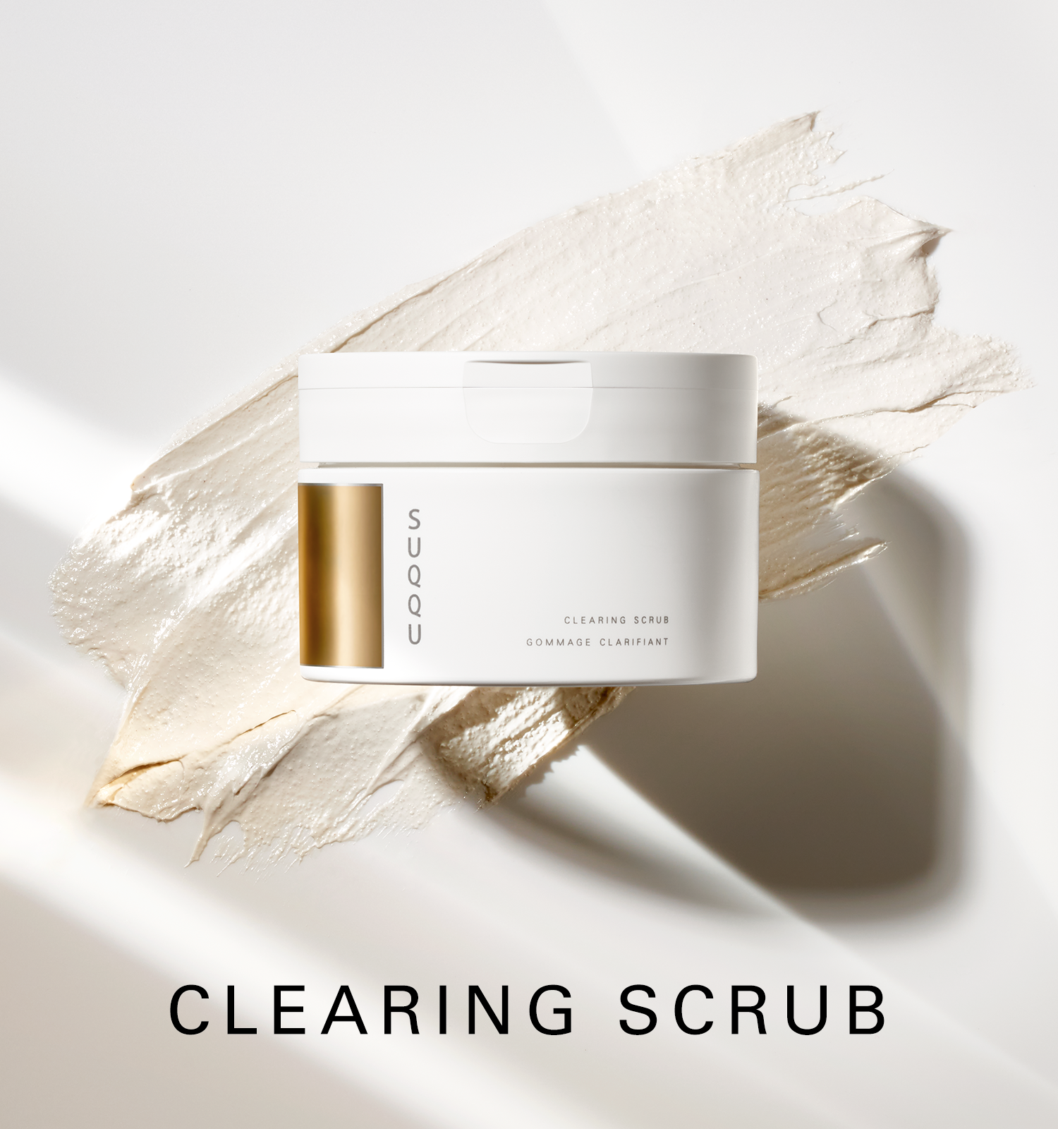 SUQQU Clearing Scrub face cleanser tub with texture swatch background