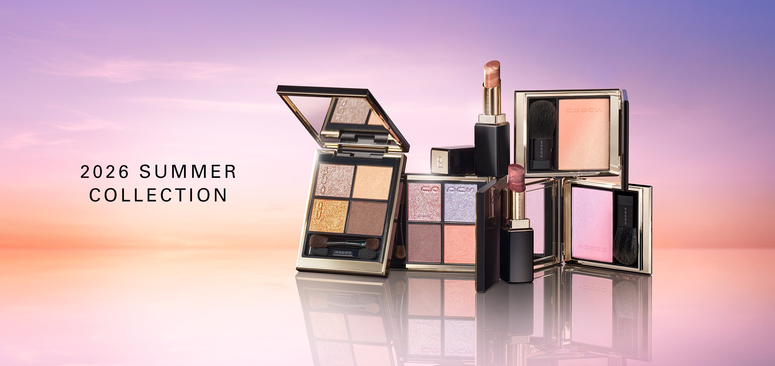 SUQQU 2026 Summer Collection colourful luxurious makeup products on sky gradient horizon background. Including two beautiful quad eyeshadow palettes, two cheek blusher / highlighters and two lispticks. SUQQU - The highest quality skincare and cosmetics from Japan.