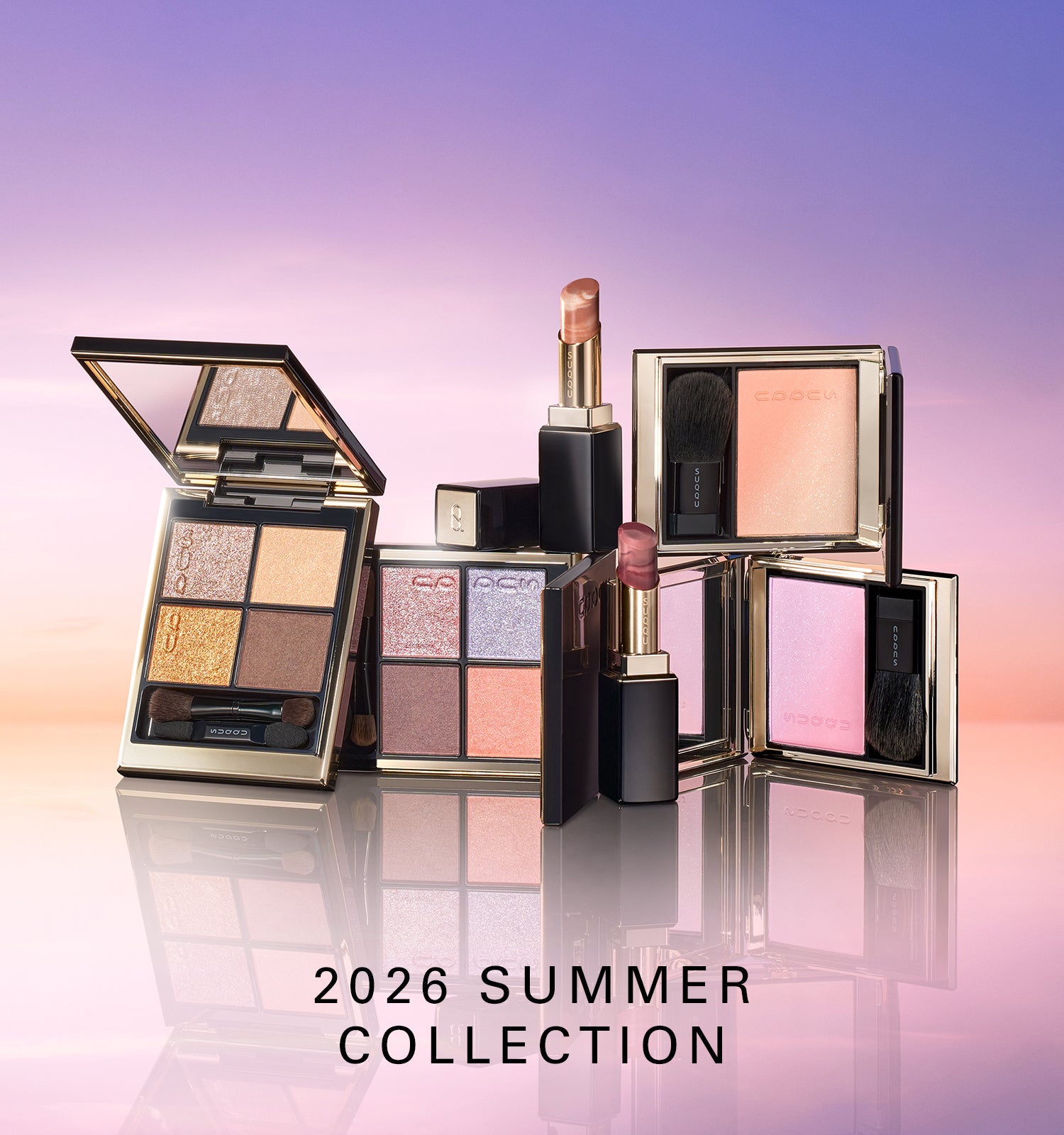 SUQQU 2026 Summer Collection colourful luxurious makeup products on sky gradient horizon background. Including two beautiful quad eyeshadow palettes, two cheek blusher / highlighters and two lispticks. SUQQU - The highest quality skincare and cosmetics from Japan.