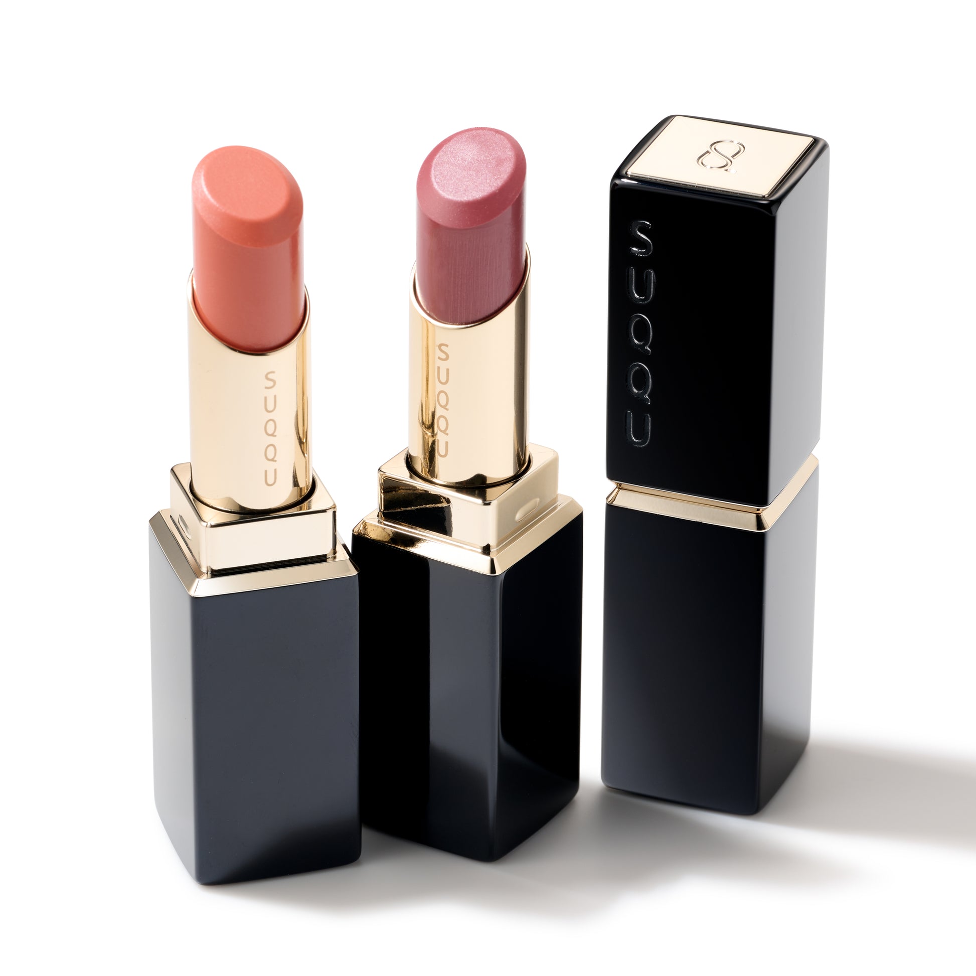 SUQQU Moisture Glaze Lipstick 107 and 108 on plain background with closed product case
