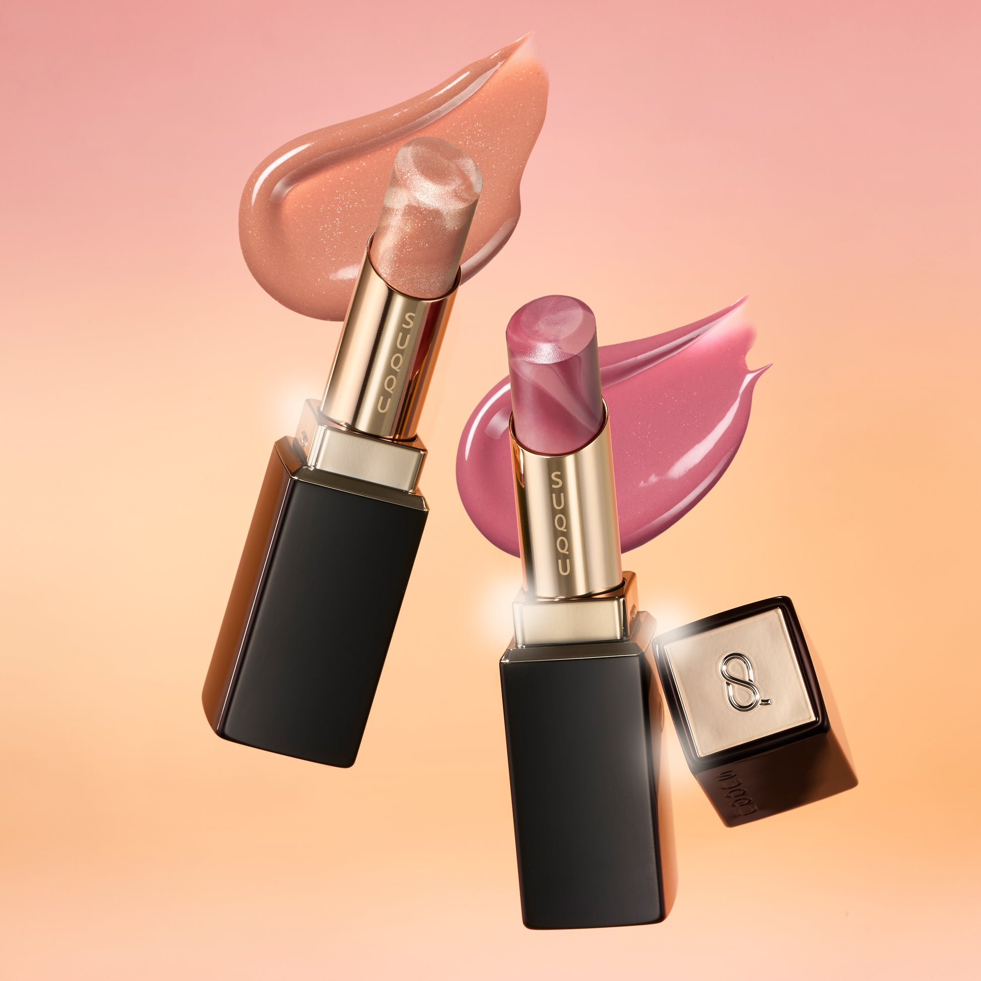 SUQQU 2026 Summer Collection, multiple beautiful colourful luxury makeup products on a gradient sky background. Two lipsticks in orange red and grape red with texture swatch.