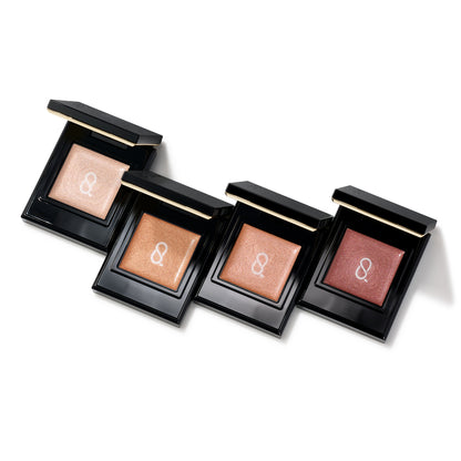 Four SUQQU Mono Look Eyes e Mellow Shine single colour eyeshadows open on a table