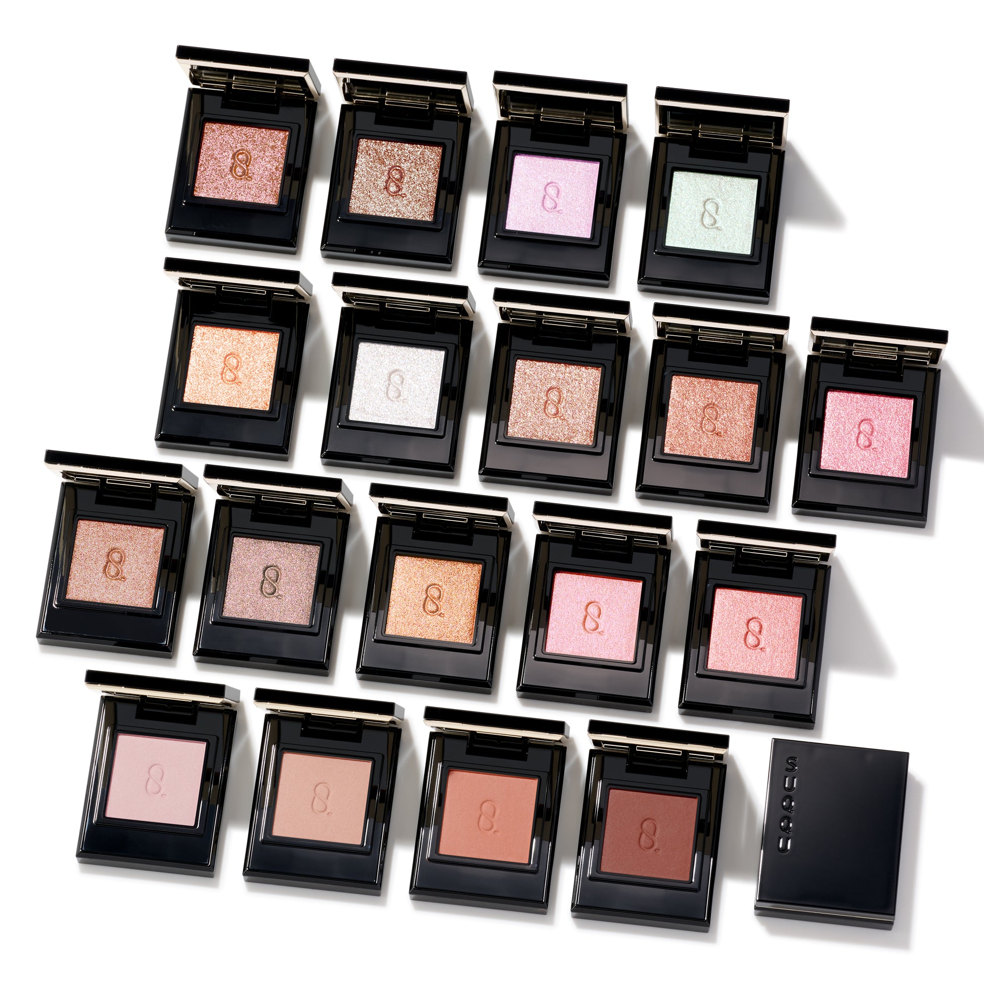 SUQQU Mono Look Eyes range of luxurious, best quality creamy powder eyeshadows from Japan. Group of 18 single colour palettes with lid open.