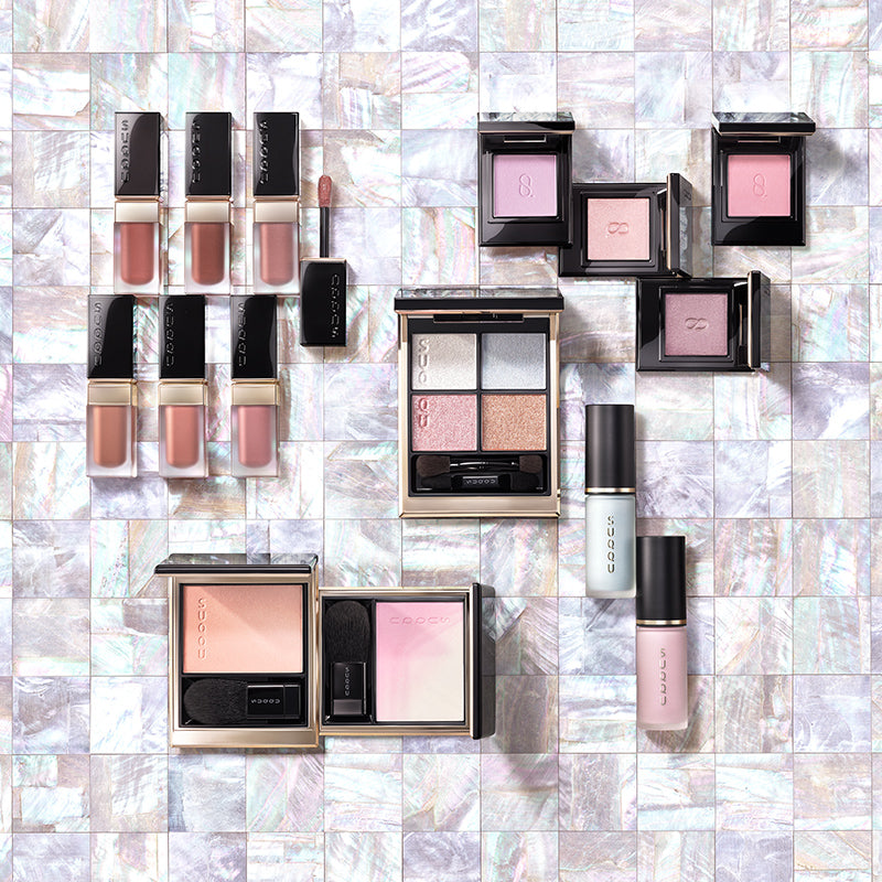 SUQQU Autumn Colour Collection 2026. 'Raden' themed multiple pearl toned colour makeup up products open on shell tiles. 6 Luxury liquid lipsticks, 5 eyeshadows and 4 cheek blushers.