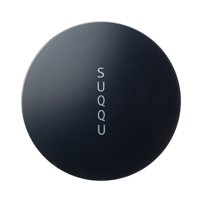 SUQQU Oil Rich Glow Loose Powder face powder make up product lid on plain background.