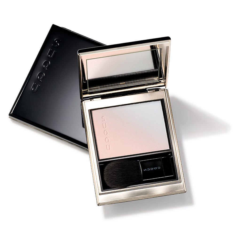 SUQQU Spring Collection 2026 Blurring Color Highlighter 101 luxury makeup palette open on a table above a closed palette.
