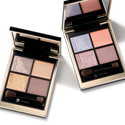 Two SUQQU Signature Color Eyes eyeshadow palettes open with gold and pink coral tones.