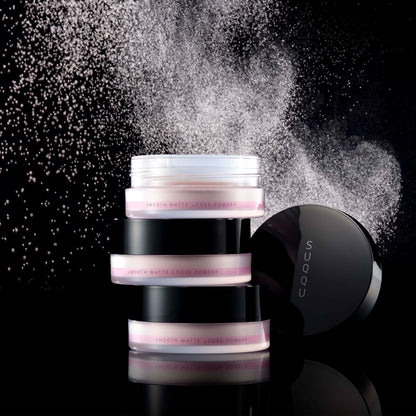 Three stacked SUQQU Smooth Matte Loose Powder pots lid open with powder texture