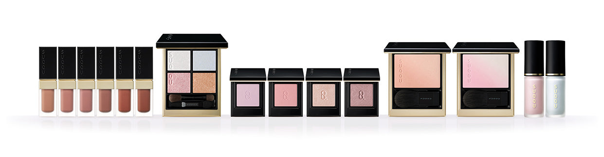 SUQQU Autumn Colour Collection 2026. 'Raden' themed multiple pearl toned blue/pink colour makeup up products open on table. 6 Luxury liquid lipsticks, 5 eyeshadows and 4 cheek blushers.