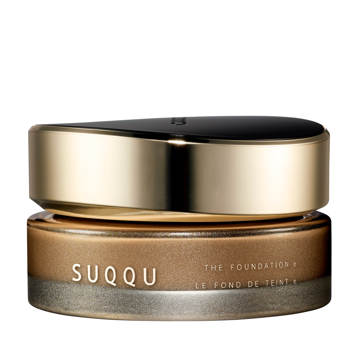 SUQQU The Foundation e 050 luxury cream base makeup jar on plain white background with gold and black lid and frosted glass base. Medium brown coffee cream foundation shade.