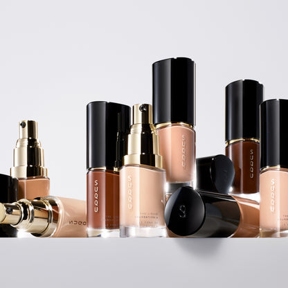 Multiple SUQQU The Liquid Foundation e products standing on a table.