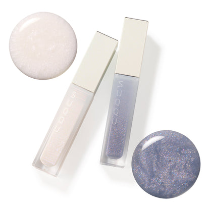 SUQQU Treatment Wrapping Lip 102 and 103 colour makeup products on plain background with liquid textures.