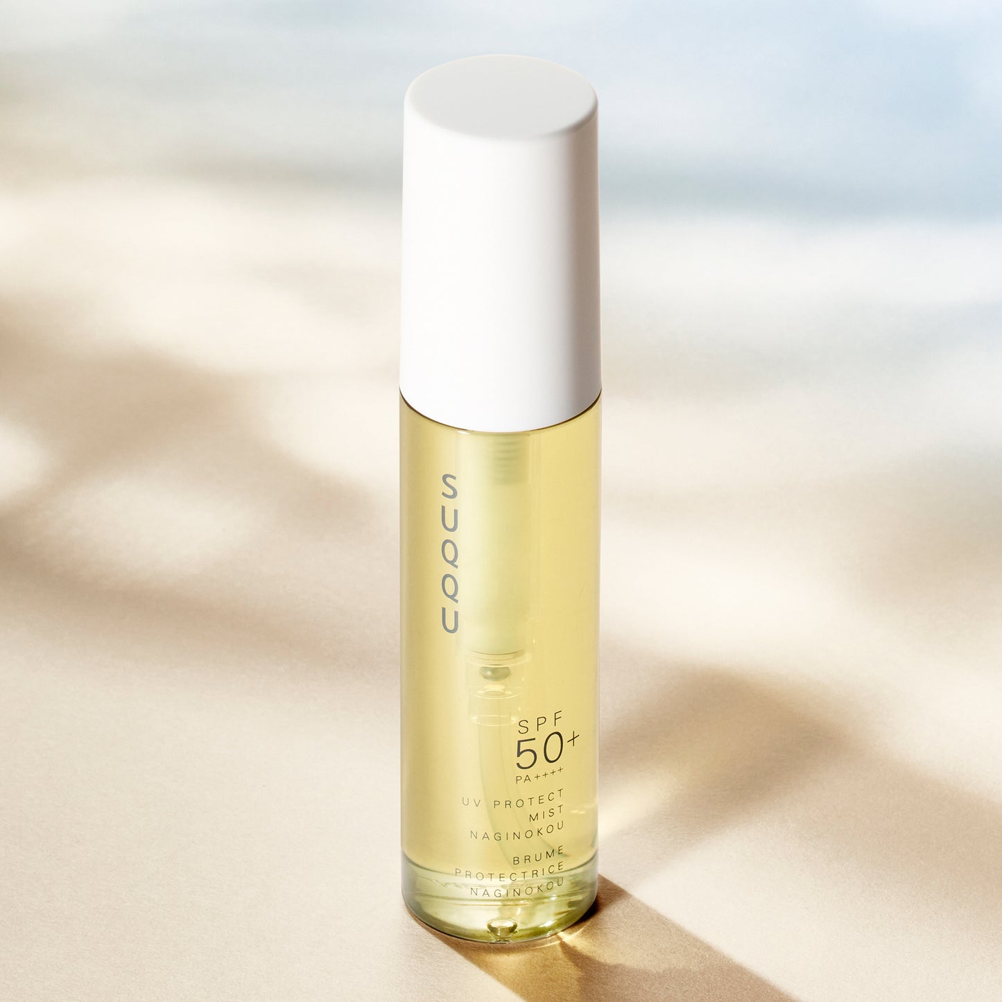 SUQQU UV Protect Mist Naginokou SPF 50 reliable Japanese premium sun care pump bottle in sunlight.