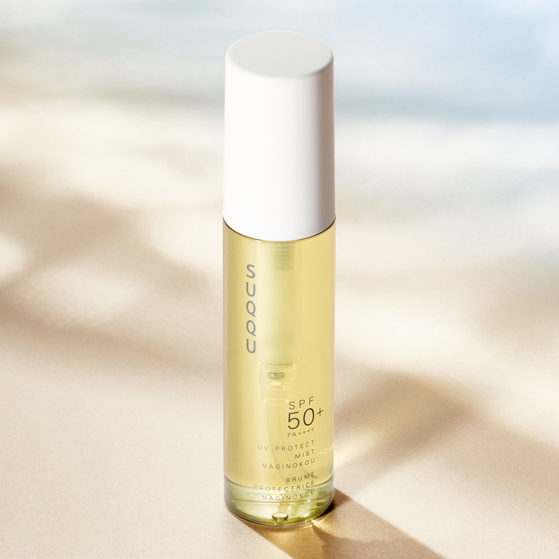 SUQQU UV Protect Mist Naginokou SPF 50 reliable Japanese premium sun care pump bottle in sunlight.