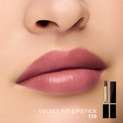 Close-up of a model's lips wearing a semi-matte deep dusty rose pink lipstick, with the text 'VELVET FIT LIPSTICK 110' and a small product inset showing the lipstick tube and case on the lower right.