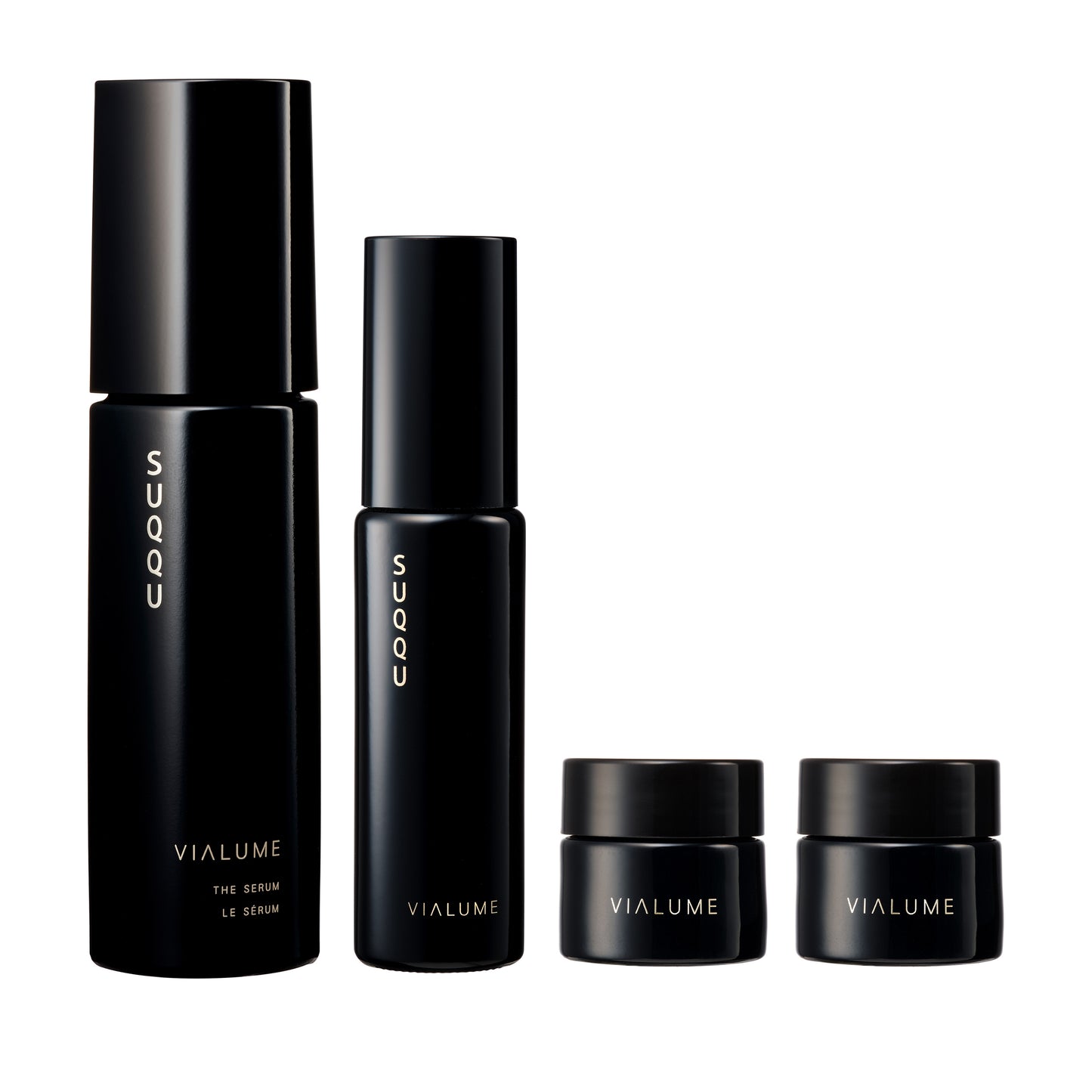 SUQQU Vialume The Kit C four luxury Japanese skincare products on a plain background. Serum, lotion, anti-ageing cream and face cream moisturisers.