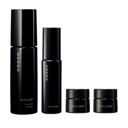 SUQQU Vialume The Kit C four luxury Japanese skincare products on a plain background. Serum, lotion, anti-ageing cream and face cream moisturisers.