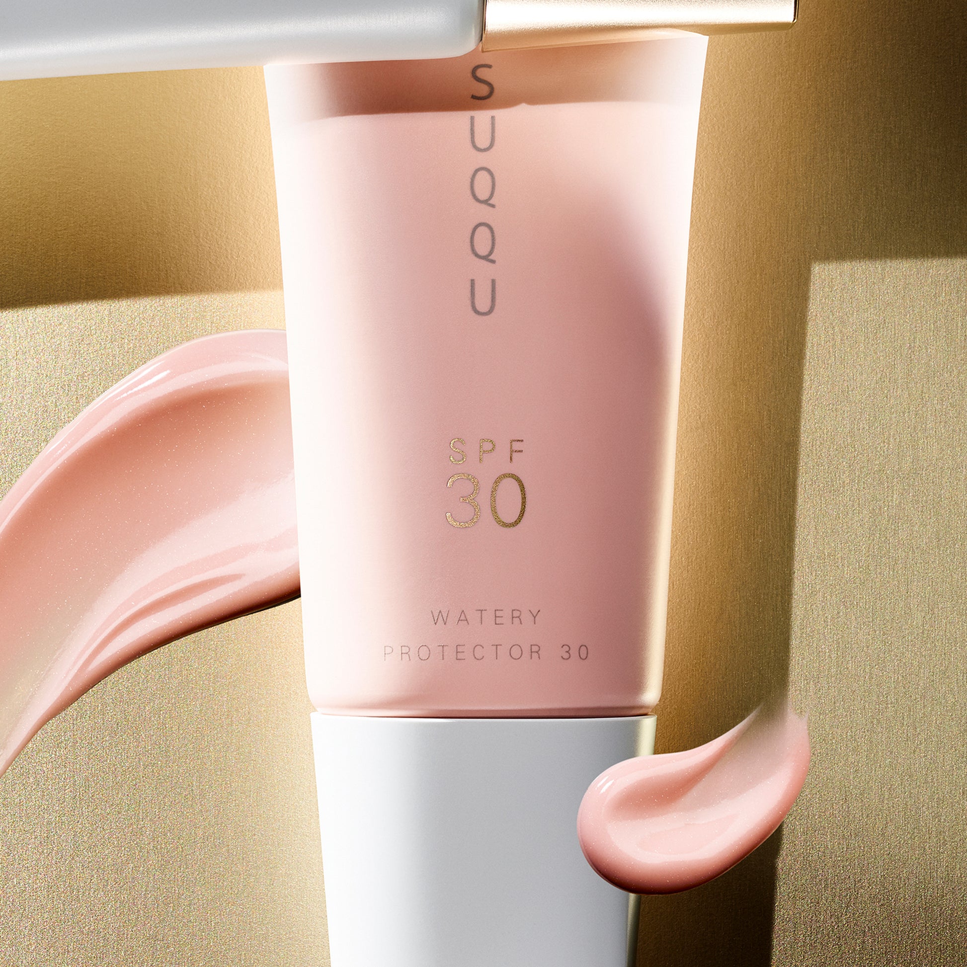 SUQQU Watery Protector 30 product tube close up with texture swatch