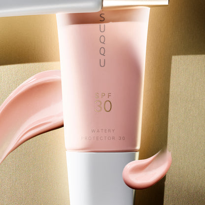 SUQQU Watery Protector 30 product tube close up with texture swatch