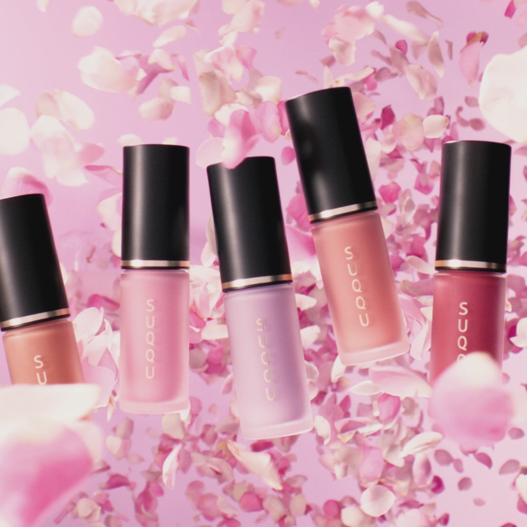 SUQQU Complexion Face Color liquid blusher products in moving petals and model portrait wearing the blusher on her cheeks.