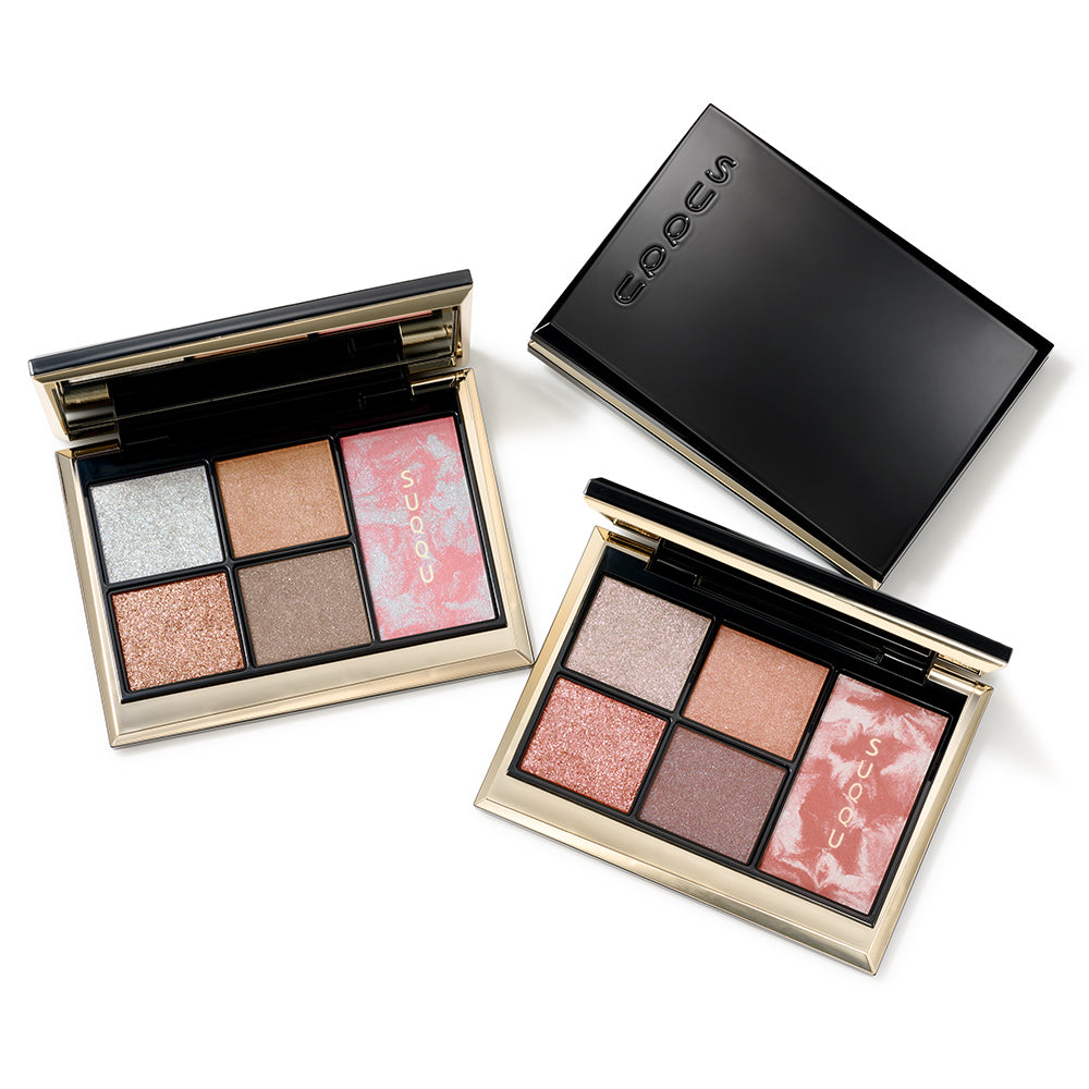 Three SUQQU Eye & Face Compact cosmetic palettes arranged on a white background: one closed black compact with the SUQQU logo, and two open palettes in 103 and 104 shades, showing shimmer and matte shades in silver, pink, bronze, taupe, and mauve tones. Quad-eyeshadow and single blusher combination Christmas gift makeup palettes.