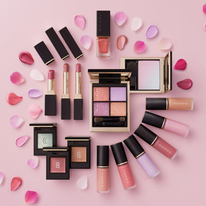 Spring color collection 2026 various colour makeup products arranged in a circle with petals.